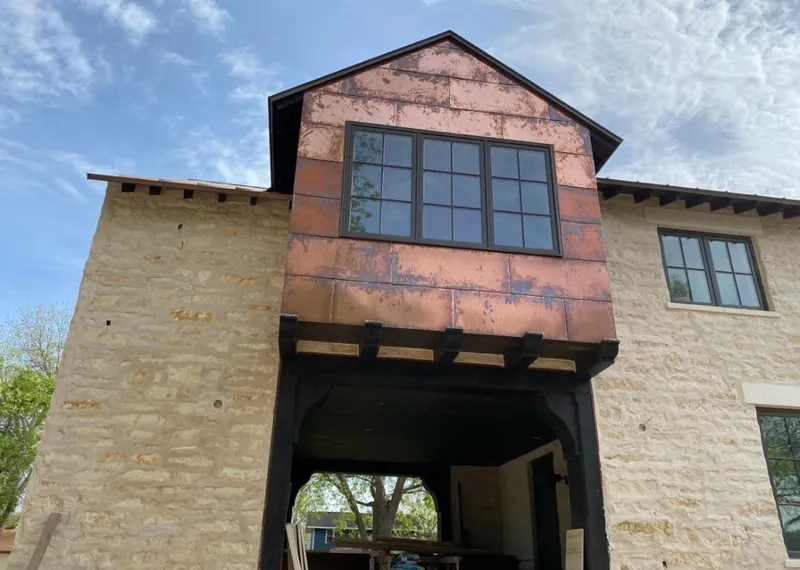 Copper metal panel facade on a stone building for Skylight Installation in Upper Nazareth